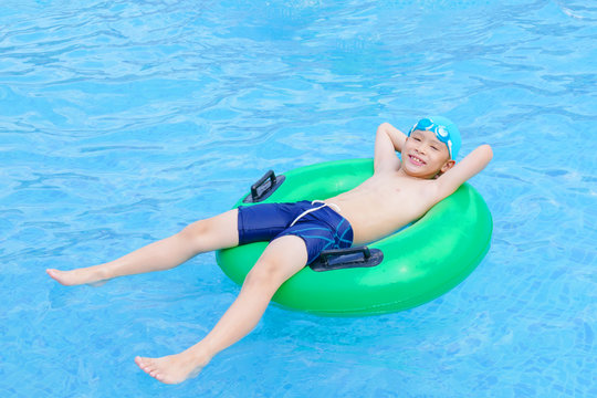 Young asian boy happy at swimming pool