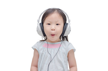 Little asian girl listening music by headphone