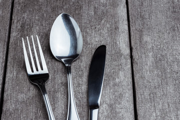 Vintage silverware on rustic wooden background