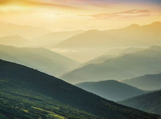 Hills during sunrise in mountain valley. Beautisul natural landscape