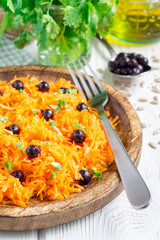 Healthy vegetarian salad with carrot, black currant, cilantro, sunflower, sesame
