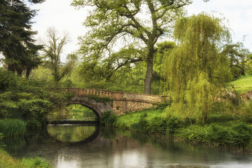 Fototapeta premium Stunning landscape image of old medieval bridge over river with