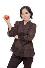 Middle aged asian woman holding an apple over white