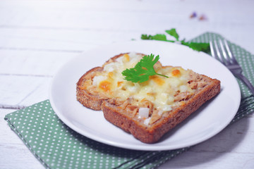 tuna bread and cheese melt on top for breakfast