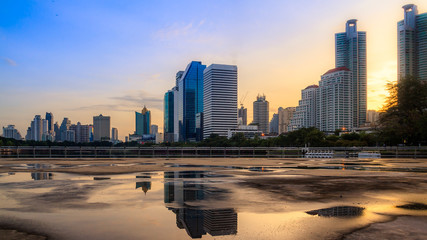 Plakat Bangkok city sunrise reflection river of sun. Panoramic view light blue background of glass high rise building skyscraper commercial of future. Business concept of success industry tech architecture