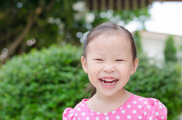 Cute asian little girl in park on summer day