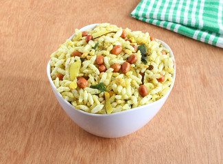 Spicy puffed rice, a popular and traditional Indian snack, in a bowl.