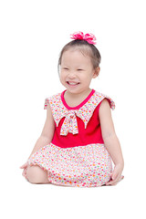 Little asian girl sitting on the floor and smiles