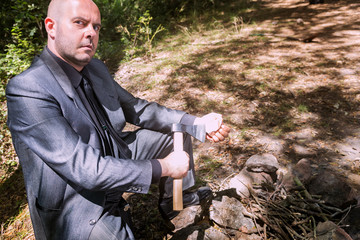 Crazy bald guy in a suit with an axe