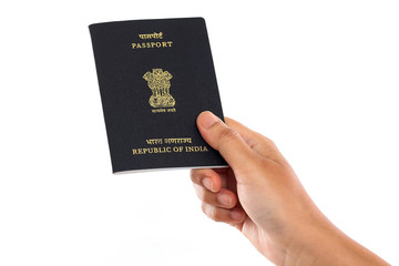 Hand holding Indian passport against white background