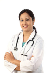Happy young female doctor against white background