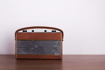 Old retro style radio on a wooden surface
