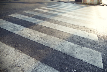 A pedestrian pathway on a street crossing 