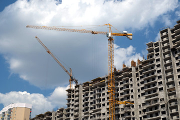 New high-rise modern apartment buildings construction in process ob bright sunny day front view horizontal