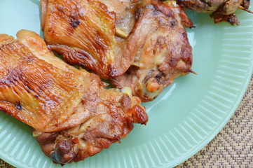 grilled chicken and entrails in wooden stick on dish