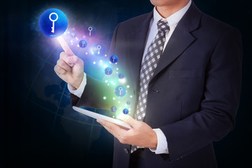 Businessman holding tablet with pressing key icon button. internet and networking concept