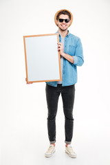 Close-up portrait of a smiling man holding blank board