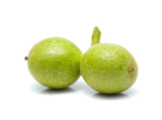 green walnuts isolated on white background
