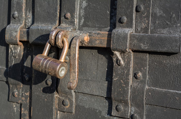 Old rusty padlock on the bolt