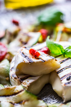 Grill Brie camembert cheese zucchini with chili pepper and olive oil. Italian mediterranean or greek cuisine. Vegan vegetarian  food.