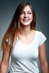 A Studio Portrait Of Smiling Teenage Girl