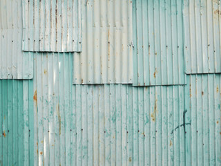 Rusty green painted metal wall with cracked paint, texture color