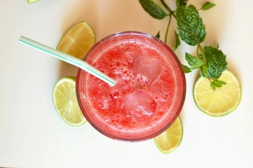 Healthy fresh smoothie drink from red watermelon, lime, mint and ice drift
