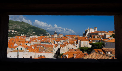 View of Dubrovnik old town through a window on the wall