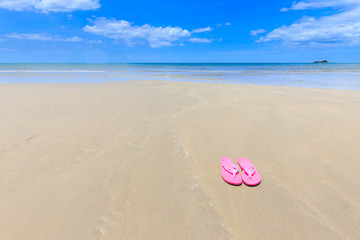 Fototapeta na wymiar Pink sandals on the beautiful beach