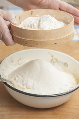 Women's hands preparing flour before baking pie