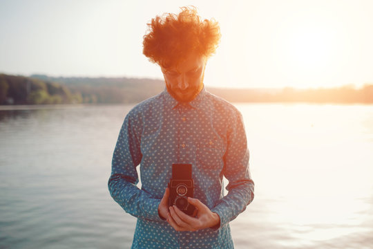The red-haired guy holding a medium format film camera in his hands