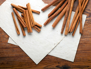 Cinnamon sticks on rustic paper close up with copy space