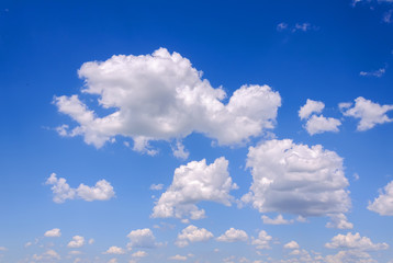 Blue sky background with tiny clouds
