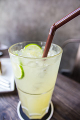 carbonated lemonade with ice in a glass, closeup
