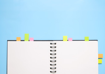 A blank journal with page markers on a blue background creating a homework themed page border