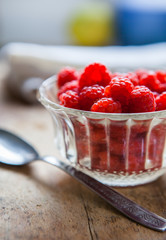 Raspberry Fruits in the kitchen prepared to eat in a ball on a woodn plate