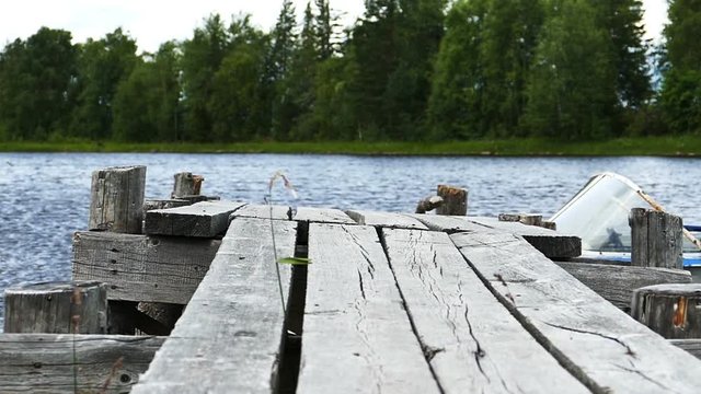 Old Wooden Pier With Motor Boad Near it