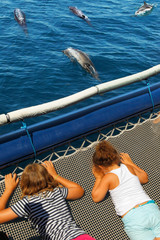 Young tourists during a dolphin watching