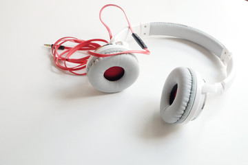 white earphones in red line on white background