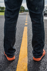 Man feet walking on road walk.