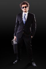 Cool businessman on black