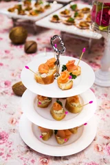 Tuinposter mini canapes with smoked salmon on table © subinpumsom