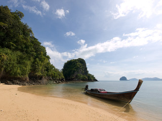 Fototapeta na wymiar Traditional long-tail boat on a beach of Koh Yao Yai island, Tha