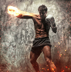 Fighter with naked torso poses in studio.