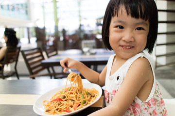 Asian Little Chinese Girl Eating spaghetti
