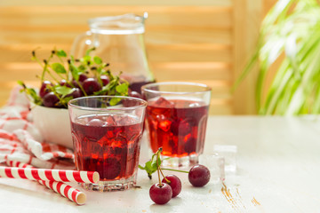 Cold cherry summer drink in glasses