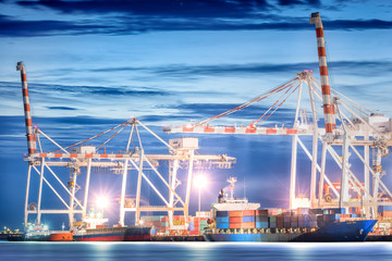 Fototapeta premium Logistic Import Export background, Container Cargo freight ship with working crane bridge in shipyard at twilight sky, Shipping, Logistics.
