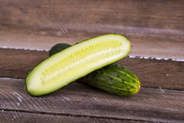 green cucumber on old boards