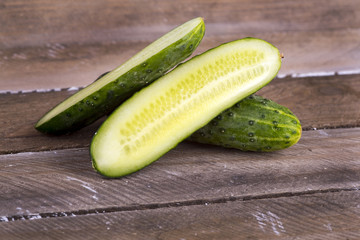 green cucumber on old boards