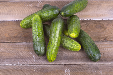 green cucumber on old boards